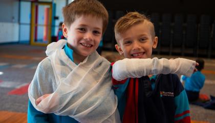 Two children in bandages at a First Aid in Schools lesson