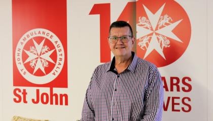An image of Peter Werrener smiling at the camera, stood in front of a SJQ graphic background with the logo.