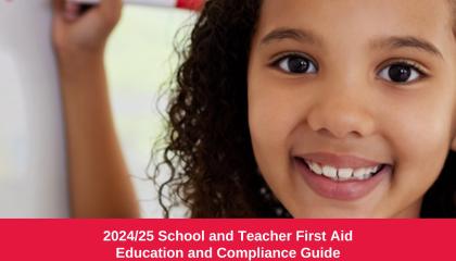 An image of a young school aged child smiling at the camera and drawing on a whiteboard. Image is footed by '2024/25 School and Teacher First Aid Education and Compliance Guide'.