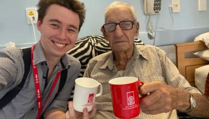 Image of St John community volunteer and client drinking tea.