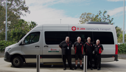 Staff standing in front of St John bus