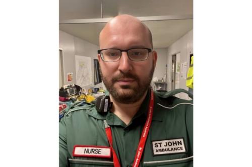 A selfie photo of Jamie, a SJQ volunteer wearing his full uniform.