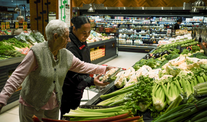 Community worker helping elderly lady do her groceries