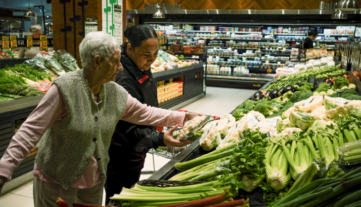 Community worker helping elderly lady do her groceries