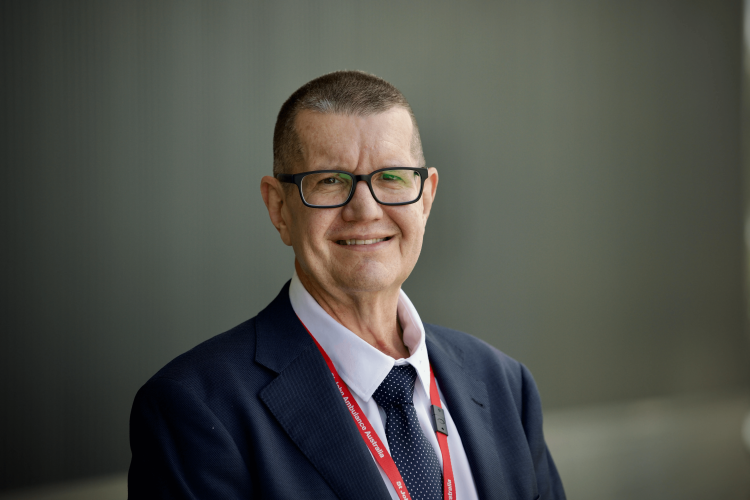A headshot of Peter Warrener