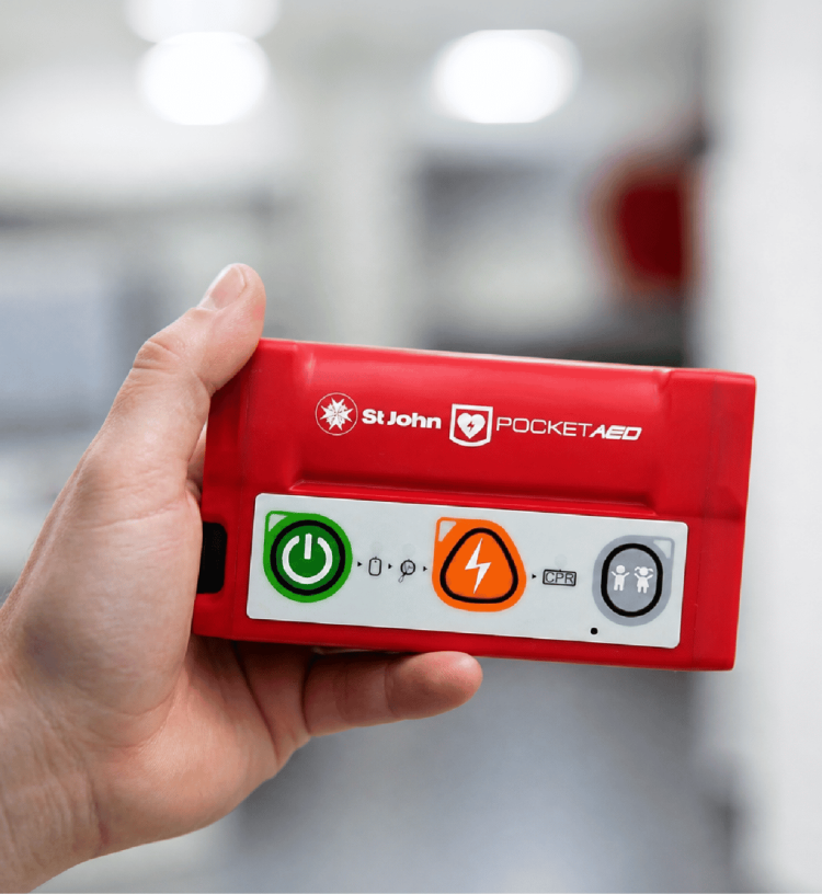 An image of someone holding a pocket AED