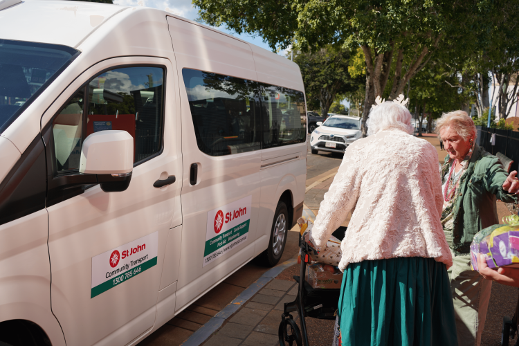 An elderly woman approaching a van to get into