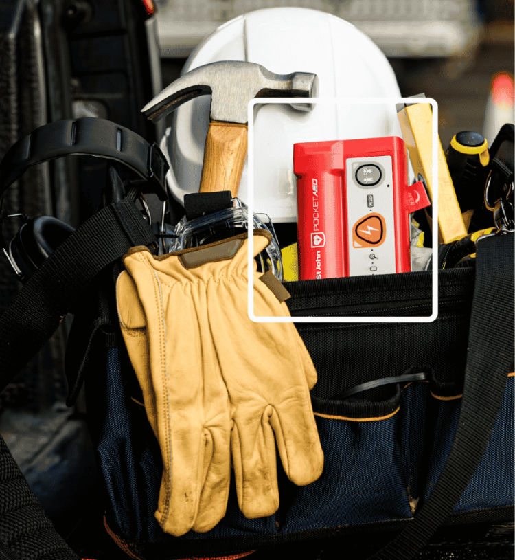 An image of a pocket AED in a tradies work bag.