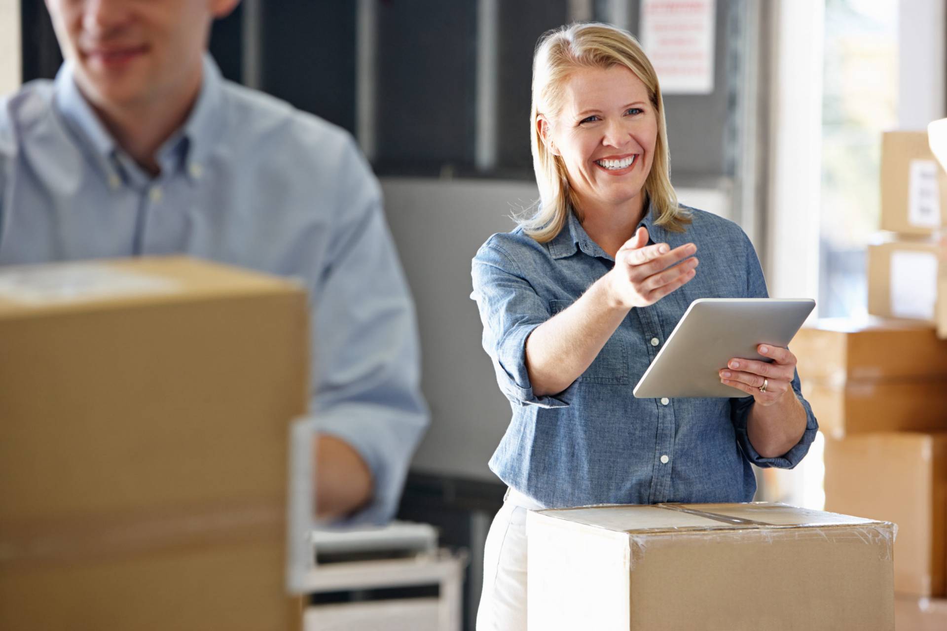 Manager Using Tablet Computer In Distribution Warehouse